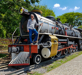 Mature man on a restored steam locomotive