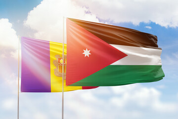 Sunny blue sky and flags of jordan and andorra