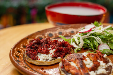 Traditional Mexican sopes with spicy meat and vegetables