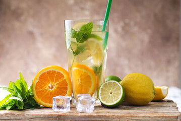 glas with lemonade or mojito cocktail with lemon and mint, cold refreshing drink or beverage with ice.