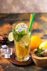 glas with lemonade or mojito cocktail with lemon and mint, cold refreshing drink or beverage with ice