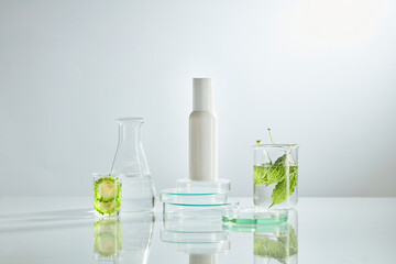 Front view of bitter melon with cosmetic jar decorated with laboratory equipment in green background 