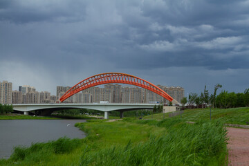 Changchun, Jilin - June 3 2021: Modern bridge by a city park in summer.