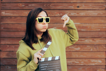 Unhappy Actress Holding Film Slate Making Thumbs Down Gesture