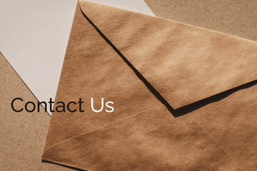 Contact us banner for customer support web page, brown envelope and white paper note