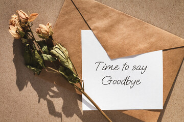 Time to say goodbye note, envelope and dry roses