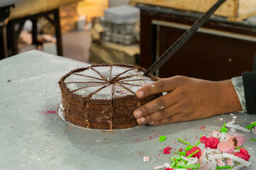 Kolkata, West Bengal, India - 29th December 2019 : Nahoum and Sons, New Market area is a very famous and old cake shop. Sales people are busy selling cakes over the sales counter inside the shop.