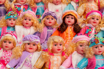 Colourful tiny girl baby dolls for sale at retail shop at Christmas market, New Market area, Kolkata, West Bengal, India.