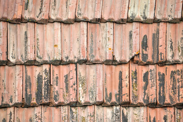 Closeup surface of old weathered ceramic tiles covering building roof