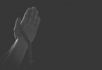 Praying hands with faith in religion and belief in God on dark background. Power of hope, love and devotion.