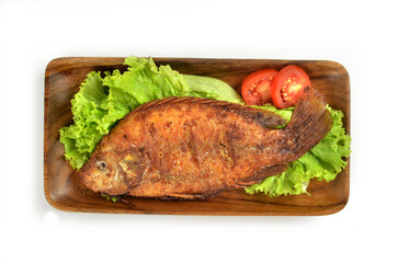Fried fish with vegetables on a dish, Indonesian food.