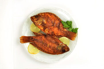 Fried fish with vegetables on a dish, Indonesian food.