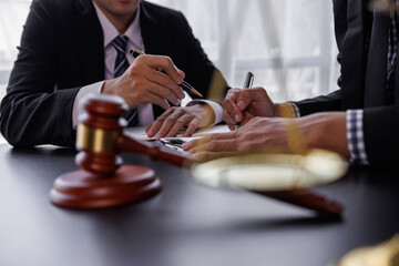 justice and law concept. male lawyer working in an office. Legal law, advice, and justice concept. The client is bringing the documents to clarify the law to the lawyer at the prosecutor's office.	