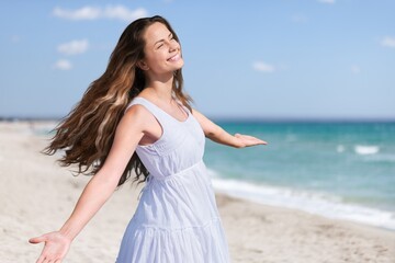 Fototapeta na wymiar Free happy woman with open arms enjoying nature breathing fresh air. Enjoyment, freedom, happiness and mental health concept