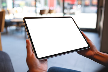 Mockup image of a woman holding digital tablet with blank white desktop screen