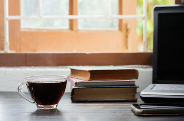 the coffee cup is placed on the desk. office or at home with a notebook computer keyboard tablet pc