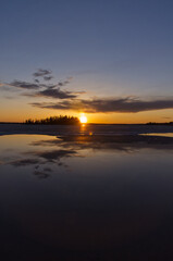 Fototapeta na wymiar Evening Sunset over a Partially Frozen Lake