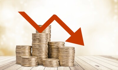 Stack of coins bar chart and graph trending downwards. Economy recession crisis, inflation,...