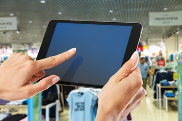 Smart store management systems concept. Manager using digital tablet on blurred store as background