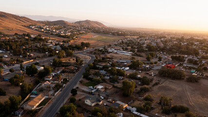 Sunset aerial view of the city and surrounding mountains of Jurupa Valley, California, USA.