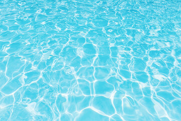 Ripple water in swimming pool with sun reflection
