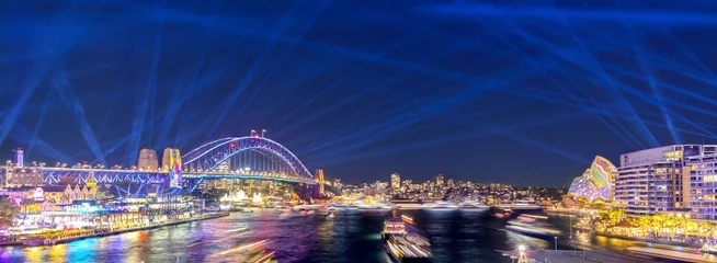 Foto op Canvas Colourful Light show at night on Sydney Harbour NSW Australia. The bridge illuminated with lasers and neon coloured lights  © Elias Bitar