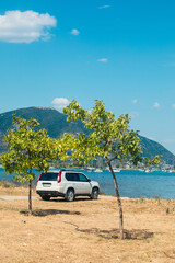Fototapeta na wymiar suv car at the beach of sea bay Lefkada island
