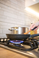 frying pan on cooking top blue flame