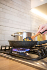 frying pan on cooking top blue flame