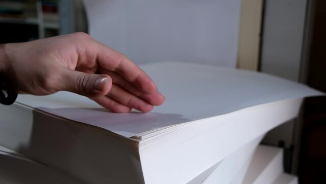 hand holding stack of papers, close up
