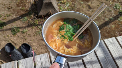 Eating pho(Vietnamese rice noodles) in a cooking pan at porch