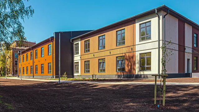 Exterior view of wood container house which is a local school at daytime in timelapse.