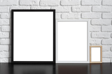 Blank picture frame against brick wall with copy space