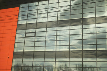 Fototapeta na wymiar Glass building. Mirrored windows in house.