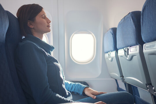 Fear Of Flying Woman In Plane Sick With Stress Headache And Motion Sickness Or Airsickness. Travel With Airplane With Aerophobia Is Afraid To Fly, Sitting On Seat Of Plane.