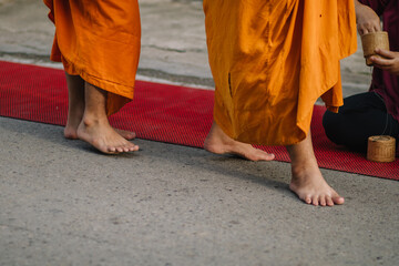 Monks walk for alms in the morning at Chiang Khan, Loei Province, Thailand