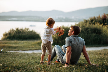 dad and son play on the seashore, vacation with children. Summer adventure, fun trip with kids. Fatherhood, Father's Day. Happy family travel and vacation concept - Powered by Adobe