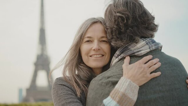 Happy senior couple in Paris. Senior woman and man spending time together at the eiffel tower. Concept about european tourism and landmarks	
