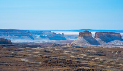 The amazing desert landscape background. Beautiful landscape of desert mountains. Monolithic mountains in the central area of the desert. Stones, bushes and the sky.