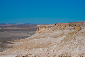 The amazing desert landscape background. Beautiful landscape of desert mountains. Monolithic mountains in desert. Stones and the sky. Bizarre sandstone cliffs in the desert.