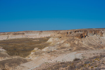 The amazing desert landscape background. Beautiful landscape of desert mountains. Monolithic mountains in desert. Stones and the sky. Bizarre sandstone cliffs in the desert.