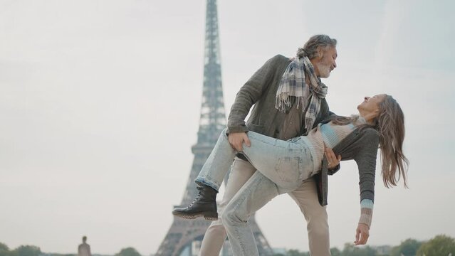Happy senior couple in Paris. Senior woman and man spending time together at the eiffel tower. Concept about european tourism and landmarks	