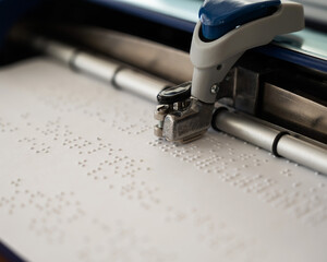Close-up of a braille code printing machine. 