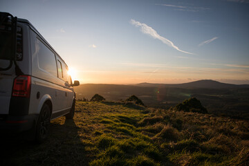 White travel campervan car mountain view sunset sky explore rural solo traveller camp holiday...