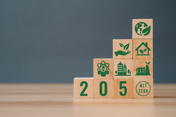 Wooden cubes with net zero icon in 2050 on grey background. Net zero by 2050. Carbon neutral. Net...