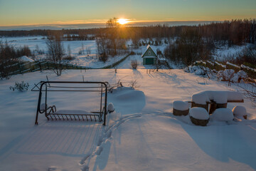 Garden on a frosty winter day at sunset