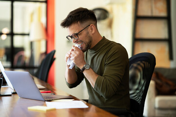 Tired businessman in office. Angry man working on laptop..
