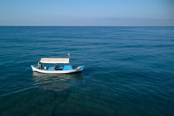 lonely fishing boat in the middle of the sea