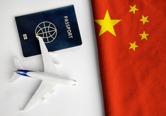 Flag of China with passport and toy airplane. Flight travel concept 