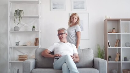 Internet privacy. Parent control. Secret content. Disturbed middle-aged dad hiding laptop screen from curious daughter passing by in modern home interior. - Powered by Adobe